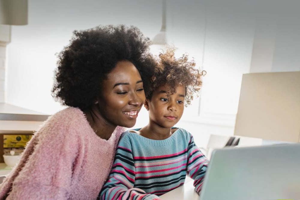 Mother and daughter participating in online learning